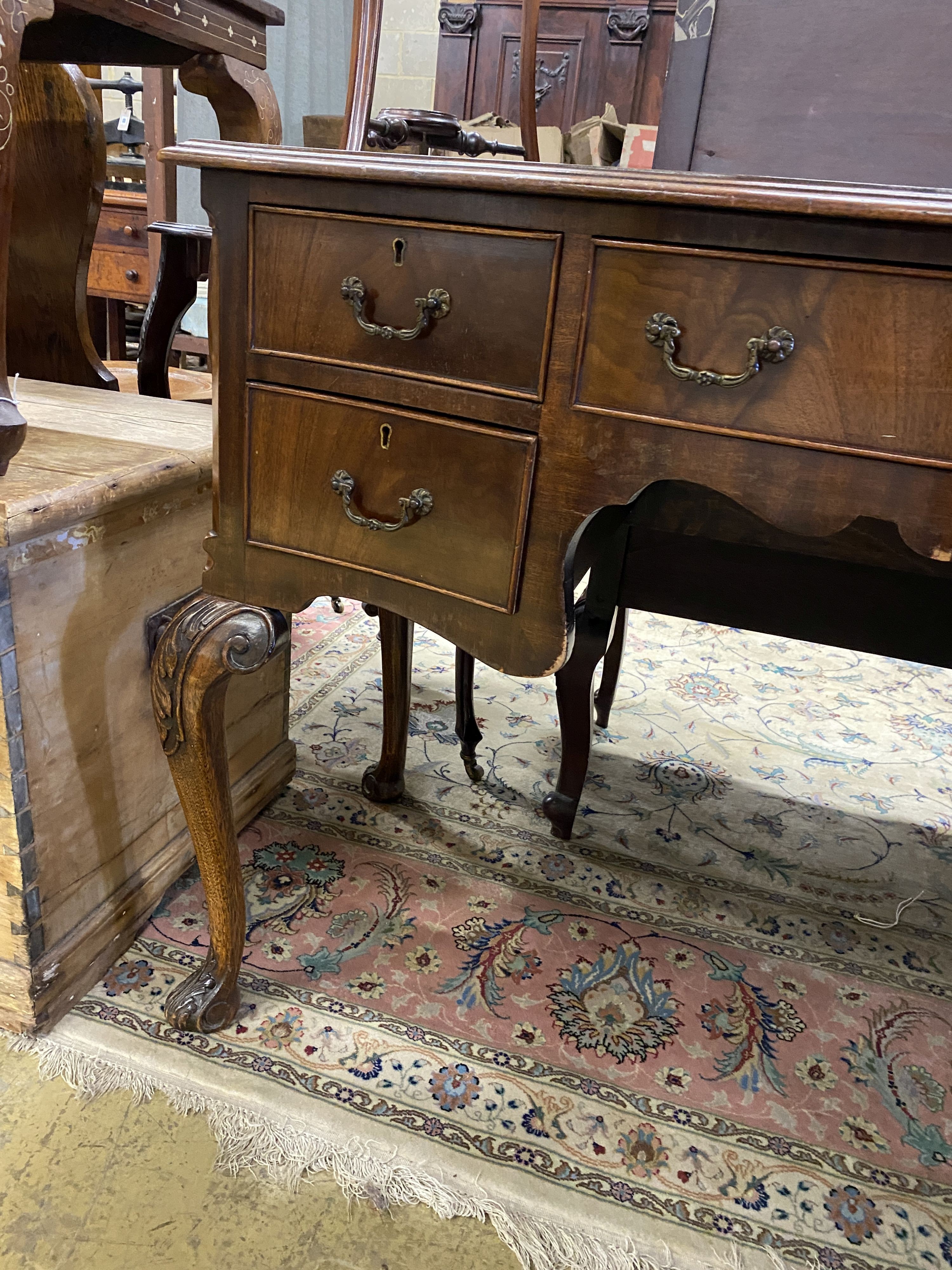 A reproduction George III style serpentine mahogany kneehole writing table, width 107cm, depth 55cm, height 78cm